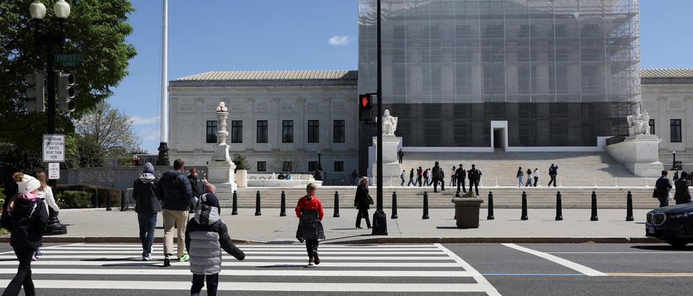 People walk near the U.S. Supreme Court building in Washington, D.C., U.S., April 8, 2025. REUTERS/Jonathan Ernst