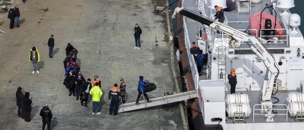 Migranten besteigen im Hafen von Shengjin im Nordwesten Albaniens ein Schiff der italienischen Küstenwache.