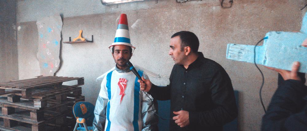 Handyvideos drehen im Camp. Yassin (Osama Hafiry, rechts) interviewt als Reporter eine „Rakete“.