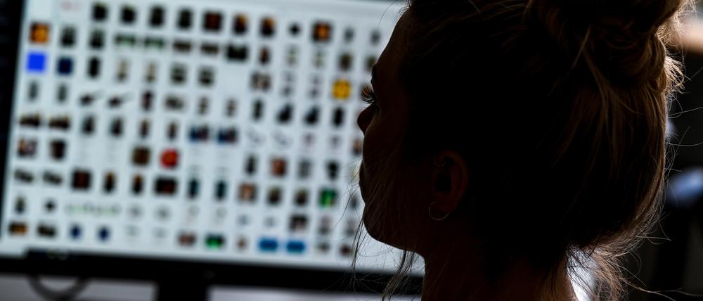 Ein Kriminaloberkommissarin sitzt in einem Büro vor einem Auswertungscomputer und ermittelt gegen Kindesmissbrauch im Internet.