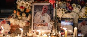 Blumen und Kerzen sind in Buenos Aires in Argentinien neben einem Foto des verstorbenen Papstes drapiert.