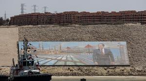 A boat moves near an image of Egyptian President Abdel Fattah al-Sisi, on the Suez Canal, on the Excellence Day, in Ismalia, Egypt, April 16, 2025. REUTERS/Amr Abdallah Dalsh