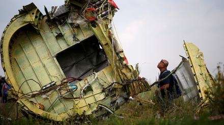 FILE PHOTO: A Malaysian air crash investigator inspects the crash site of Malaysia Airlines Flight MH17, near the village of Hrabove (Grabovo) in Donetsk region, Ukraine, July 22, 2014.  REUTERS/Maxim Zmeyev/File Photo