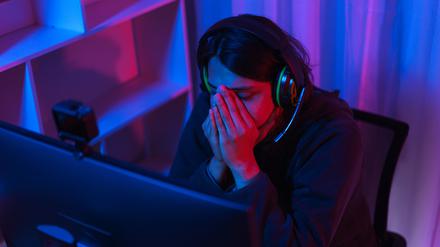 Game stream concept, Male streamer feeling stressed after live streaming of losing game tournament.