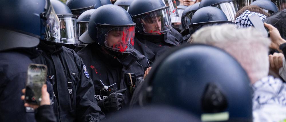 Ein Polizist hat bei einer Palästina-Demo am Nakba-Tag rote Farbe auf dem Visier. 