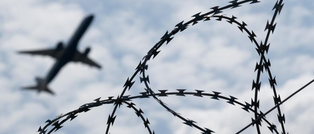 Ein Flugzeug hebt am Flughafen BER hinter einem Zaun mit Natodraht ab. (zu dpa: «US-Justiz stoppt Abschiebung von Migranten nach Südsudan») Foto: Sebastian Gollnow/dpa +++ dpa-Bildfunk +++