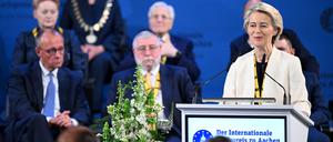 Ursula von der Leyen (r), Präsidentin der Europäischen Kommission, spricht nach der Verleihung des Internationalen Karlspreises im Rathaus - hinter ihr sitzen unter anderem Bundeskanzler Friedrich Merz (CDU, l) und Oberrabbiner Pinchas Goldschmidt (M), Karlspreisträger 2024. 