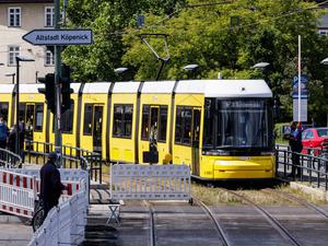 Eine Straßenbahn fährt in den gesicherten Bereich an der gesperrten Brücke an der Wuhlheide im Ortsteil Oberschöneweide. 