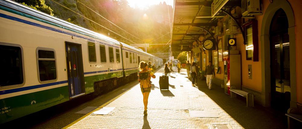 Eine Frau läuft zu ihrem Zug auf einem Bahnsteig in Italien. (Symbolbild)