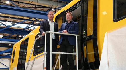 Jure Mikolčić, Geschäftsführer von Stadler Deutschland, und Jan Otto, Erster Bevollmächtigter der IG Metall Berlin, vor einem BVG-Wagen in Arbeit.