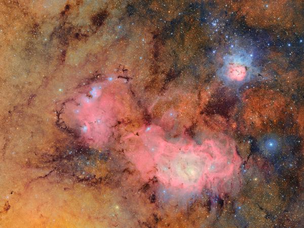 This image combines 678 separate images taken by NSF–DOE Vera C. Rubin Observatory in just over seven hours of observing time. Combining many images in this way clearly reveals otherwise faint or invisible details, such as the clouds of gas and dust that comprise the Trifid nebula (top) and the Lagoon nebula, which are several thousand light-years away from Earth. Credit: NSF–DOE Vera C. Rubin Observatory