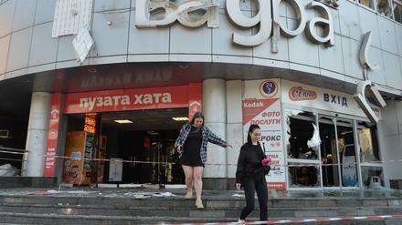 Zwei Frauen beim Verlassen eines Shoppingcenters, das bei einem russischen Angriff zerstört wurde.