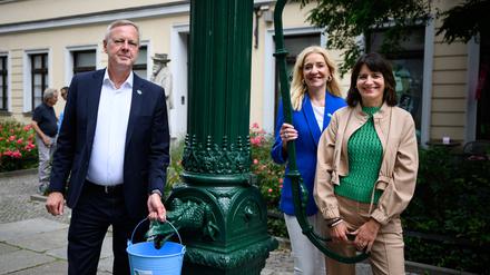 Frank Bruckmann (l-r), Vorstandsvorsitzender der Berliner Wasserbetriebe, Kerstin Oster, Vorständin Personal und Soziales der Berliner Wasserbetriebe, und Britta Behrendt (CDU), Staatssekretärin für Klimaschutz und Umwelt des Landes Berlin, an einer Schwengelpumpe im Nikolaiviertel. Berlin hat rund 2.000 solcher handbetriebenen Straßenbrunnen, die Berlin auch im Katastrophen- oder Verteidigungsfall versorgen sollen.