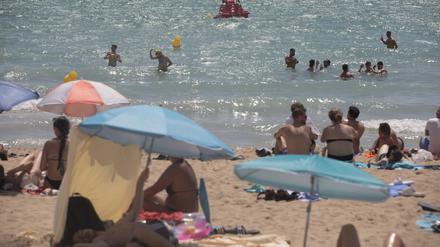 Menschen sonnen sich und schwimmen am Strand von Arenal auf Mallorca (Symbolbild).