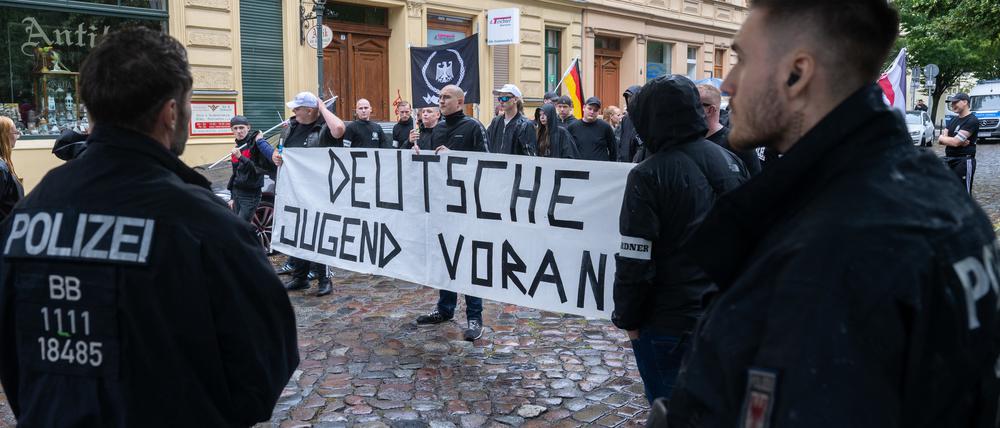 Teilnehmer stehen bei einer rechtsextremen Gegendemonstration zum Christopher Street Day in Bernau mit einem Transparent mit der Aufschrift „Deutsche Jugend voran“