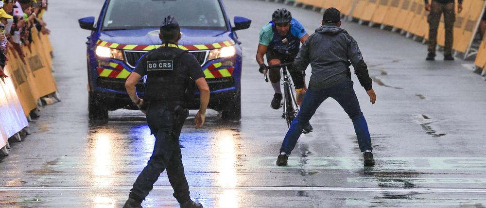 Ein Mann fuhr bei der 17. Tour-Etappe mit seinem Rad unmittelbar vor der Ankunft der Profis in den Zielbereich.