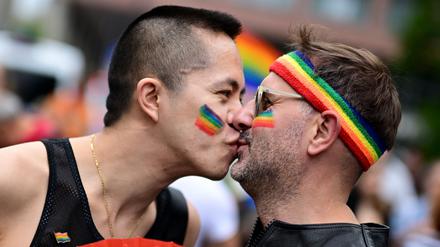 Participants of the Christopher Street Day (CSD) parade kiss as people take to the streets of Berlin on July 26, 2025 to fight for the rights of the LGBTQ+ community. The 2025 edition of the Berlin CSD is themed "Never silent again!". (Photo by Tobias SCHWARZ / AFP)
