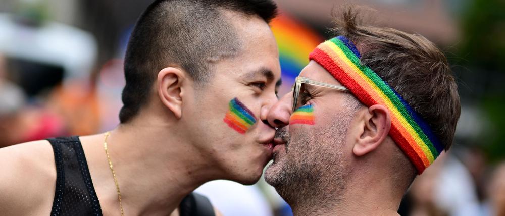 Participants of the Christopher Street Day (CSD) parade kiss as people take to the streets of Berlin on July 26, 2025 to fight for the rights of the LGBTQ+ community. The 2025 edition of the Berlin CSD is themed "Never silent again!". (Photo by Tobias SCHWARZ / AFP)