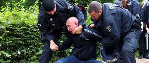 Police officers detain a demonstrator at a right-wing counter-protest against the annual Christopher Street Day (CSD) LGBTQ+ Pride march, in Berlin, Germany, July 26, 2025. REUTERS/Christian Mang