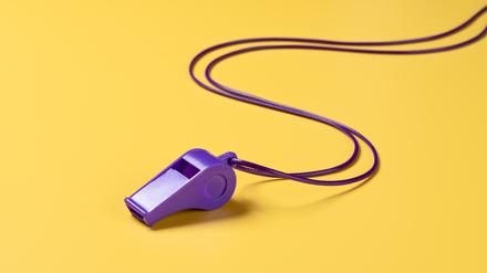 Purple Colored Plastic Whistle With Curved Lanyard on Yellow Background High Angle View.