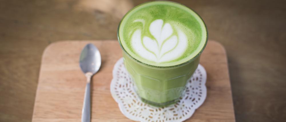 green tea latte on wood background