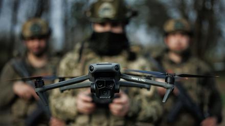 Ukrainische Soldaten steuern eine Drohne.