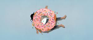 Symbolbild eines Donuts, der einen Menschen unter sich begraben hat.