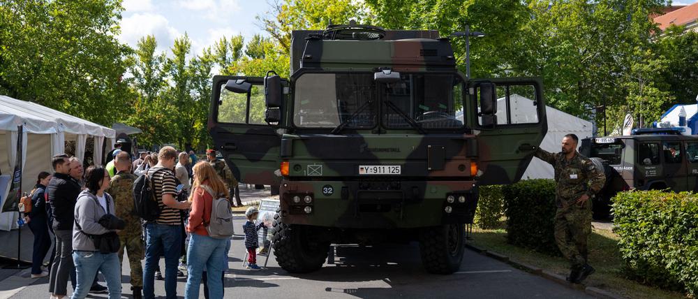 Schaulustige inspizieren Fahrzeuge der Bundeswehr am Tag der offenen Tür des Bundesverteidigungsministeriums.