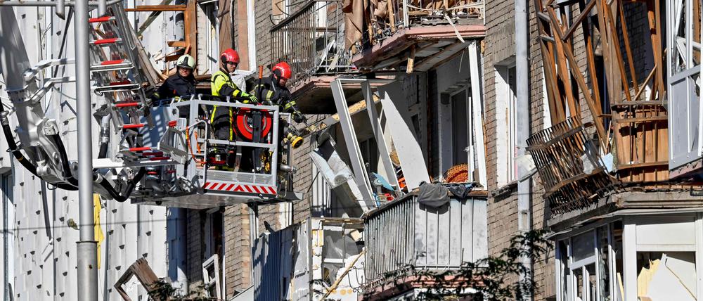 Rescuers clear debris in a residential building in a damaged area of Ukranian capital following a large-scale Russian drone and missile attacks in Kyiv on August 28, 2025, amid the Russian invasion of Ukraine. 