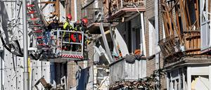 Rescuers clear debris in a residential building in a damaged area of Ukranian capital following a large-scale Russian drone and missile attacks in Kyiv on August 28, 2025, amid the Russian invasion of Ukraine. 