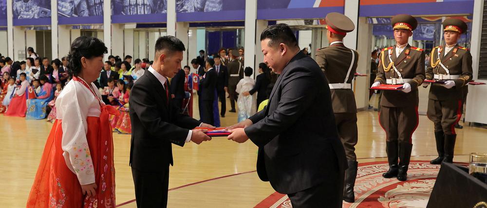 Nordkoreas Machthaber Kim Jong Un (rechts) hat sich Staatsmedien zufolge mit den Familien von Soldaten getroffen, die bei ihrem Einsatz an der Seite Russlands im Krieg gegen die Ukraine getötet wurden.