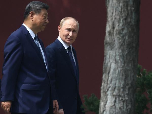 In this pool photograph distributed by the Russian state agency Sputnik, Russia's President Vladimir Putin and China's President Xi Jinping walk at Zhongnanhai leadership compound in Beijing on September 2, 2025. (Photo by Alexander KAZAKOV / POOL / AFP)