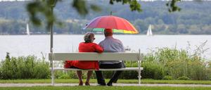 Mit ungetrübtem Blick in die Zukunft schauen: Rentner sitzen am See.
