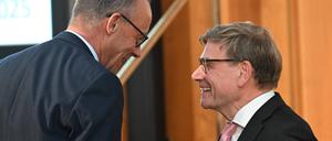 German Chancellor Friedrich Merz (L) and German Foreign Minister Johann Wadephul chat during the Conference of Ambassadors at the German Foreign Ministry in Berlin on Sepetmber 8, 2025. The conference, held from 8 to 11 September, brings together the heads of around 230 German missions abroad along with numerous high-ranking representatives from politics, business, science, and culture. (Photo by RALF HIRSCHBERGER / POOL / AFP)