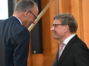 German Chancellor Friedrich Merz (L) and German Foreign Minister Johann Wadephul chat during the Conference of Ambassadors at the German Foreign Ministry in Berlin on Sepetmber 8, 2025. The conference, held from 8 to 11 September, brings together the heads of around 230 German missions abroad along with numerous high-ranking representatives from politics, business, science, and culture. (Photo by RALF HIRSCHBERGER / POOL / AFP)