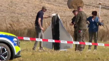 Polen, Wohyn: In diesem Videostandbild sichern Einsatzkräfte von Polizei und Militärpolizei Teile einer beschädigten Drohne, das von polnischen Behörden abgeschossen wurde. 