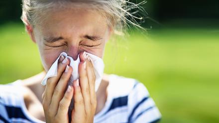 Portrait of teenage girl blowing her nose on a summer day. The girl is allergic to the pollen.
Nikon D850