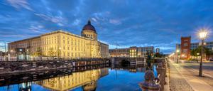 The rebuilt Berlin City Palace reflected in a small canal before sunrise