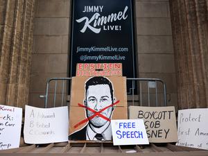 Signs are arranged during a protest at the El Capitan Entertainment Centre, where "Jimmy Kimmel Live!" was recorded for broadcast, following his suspension for remarks he made regarding Charlie Kirk’s assassination, on Hollywood Boulevard in Los Angeles, California, U.S. September 18, 2025.  REUTERS/David Swanson