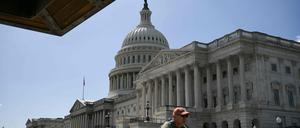 A man cycles past the the US Capitol in Washington, DC, on September 18, 2025. (Photo by Oliver Contreras / AFP)