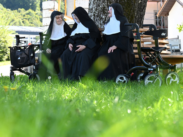 Nuns Regina, 86, Rita, 81, and Bernadette, 88, sit on a bench as they occupy their old Goldenstein convent in Goldenstein castle, near Salzburg, and refuse to move back to their retirement home, in Elsbethen, Austria, September 12, 2025. REUTERS/Angelika Warmuth