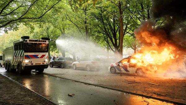 Ein Polizeiauto wird während der Demonstration gegen die aktuelle Asylpolitik der niederländischen Regierung am 20. September 2025 in Den Haag in Brand gesetzt. 