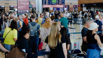 Passagiere warten an einem Terminal am Berliner Flughafen BER.