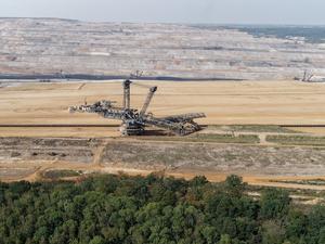ARCHIV - 30.08.2019, Nordrhein-Westfalen, Morschenich: Ein Braunkohlebagger steht im Tagebau Hambach (Luftaufnahme mit einer Drohne). Im Vordergrund ist der Hambacher Wald zu sehen.  (zu dpa: «Aktivisten besetzen Braunkohlebagger im Tagebau Hambach») Foto: Henning Kaiser/dpa +++ dpa-Bildfunk +++