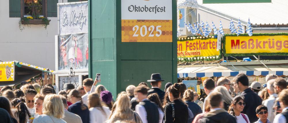Wiesn-Besucher gehen durch den Haupteingang zum 190. Münchner Oktoberfest auf der Theresienwiese. 