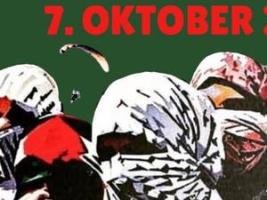 Hinter mit Palästinensertüchern Vermummten ist ein Paraglider zu sehen, darüber das Datum 7. Oktober (Grafik).