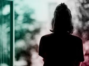 Eine Frau steht am Fenster