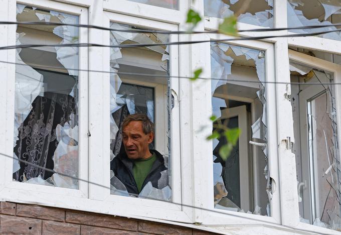 A local resident inspects a balcony of a damaged apartment building following what local Russian-installed authorities called a Ukrainian overnight drone attack, in the course of Russia-Ukraine military conflict, in Donetsk, a Russian-controlled city of Ukraine, October 8, 2025. REUTERS/Alexander Ermochenko     TPX IMAGES OF THE DAY     