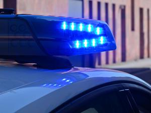 Ein Polizeifahrzeug fährt mit Blaulicht durch die Innenstadt.
