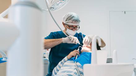Ein Zahnarzt und vor ihm ein Patient.